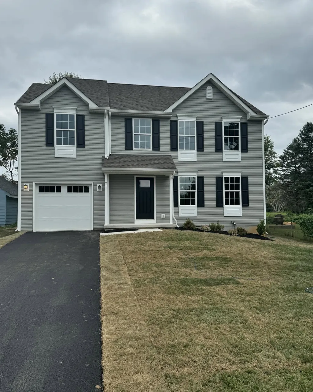 Gray two-story residence exterior renovated by Delpa Builders
